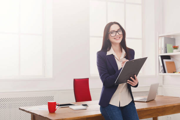 istock Business woman writing down notes at office 850775244