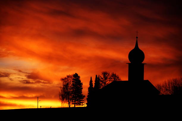 Silhouette of a church at sunrise. Bavaria, Germany.