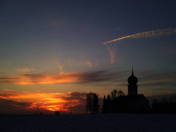 Silhouette of a church at sunrise. Bavaria, Germany.