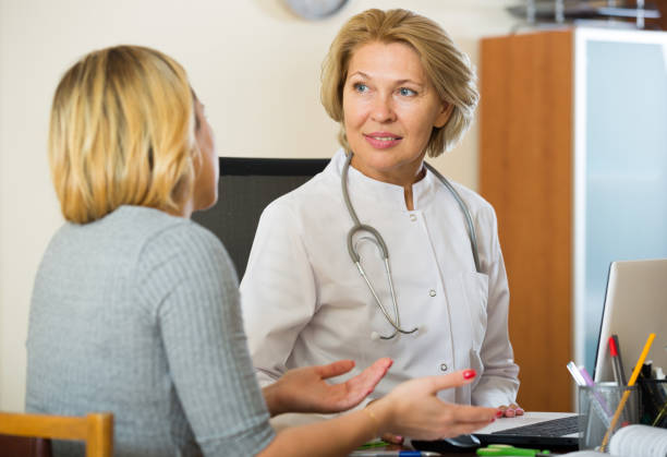 istock Elderly physician doing check up of sick female patient 850786056