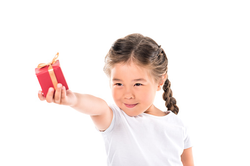 happy asian child with red gift box, isolated on white