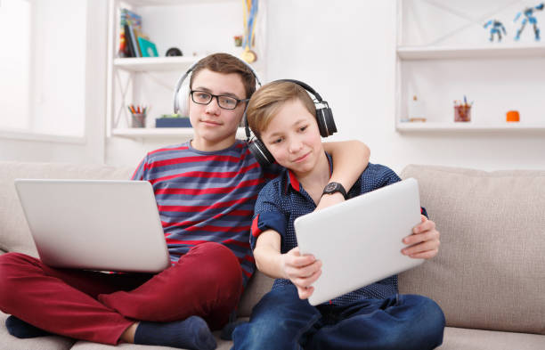 istock Two teenage boys using tablet on couch at home 850801000