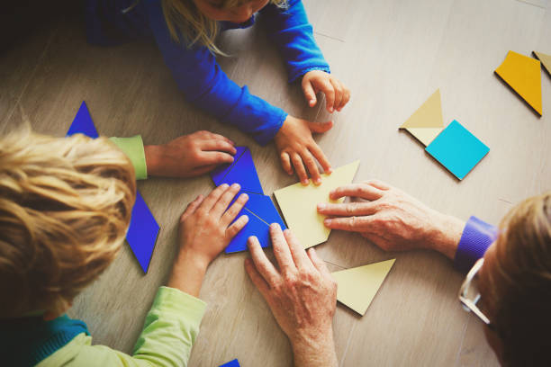istock teacher and kids playing with geometric shapes 850801606