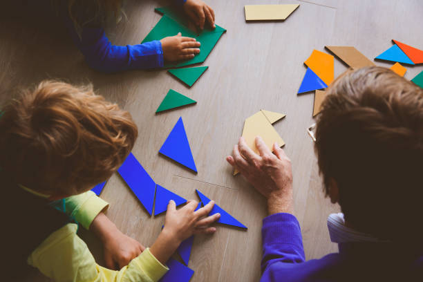 istock teacher and kids playing with geometric shapes 850801878