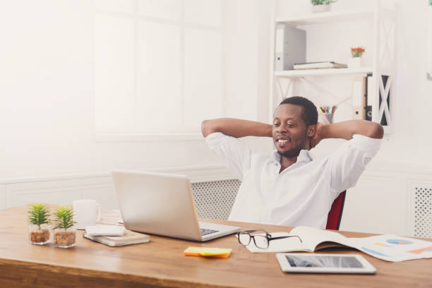 istock Young relaxed businessman with laptop in modern white office 850811952