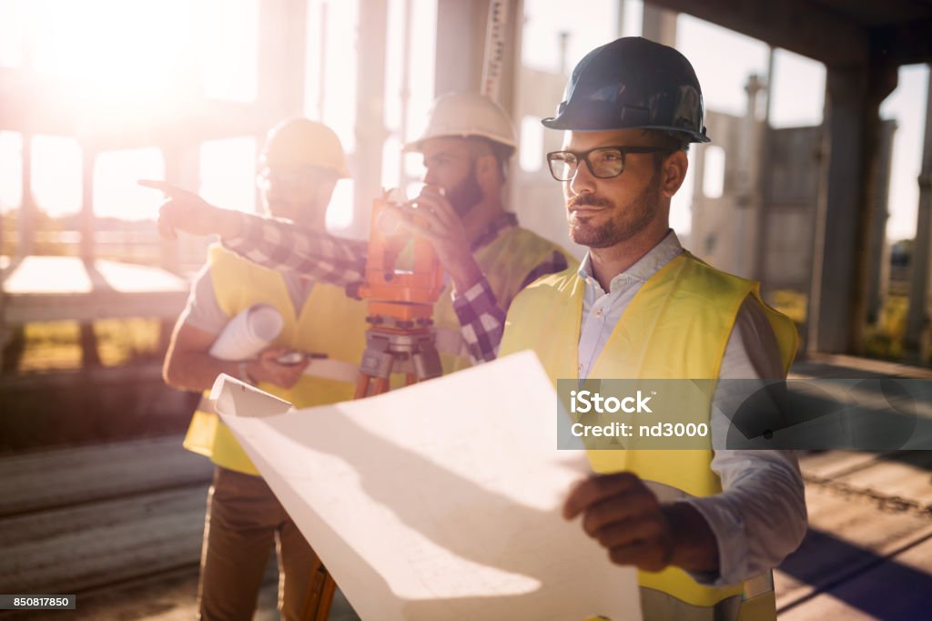 Picture of construction engineer working on building site Picture of male construction engineer working on building site Construction Site Stock Photo