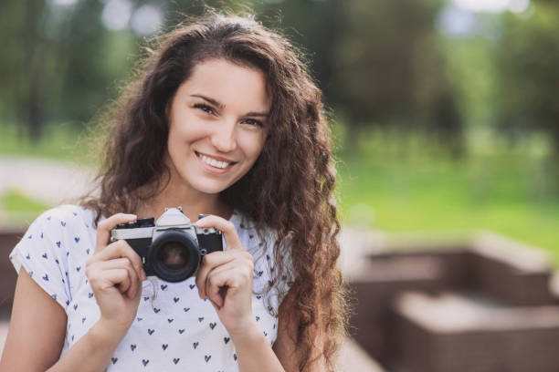 istock Happy woman holding a photo camera 850829650