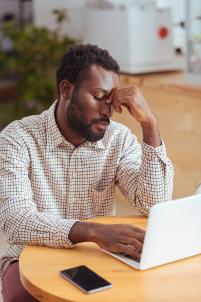 istock Tired young man working on laptop in cafe 850832386