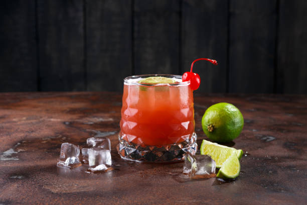istock Red cocktail with lime on brown table background 850845212