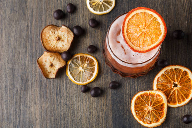 Orange cocktail with citron on wooden background