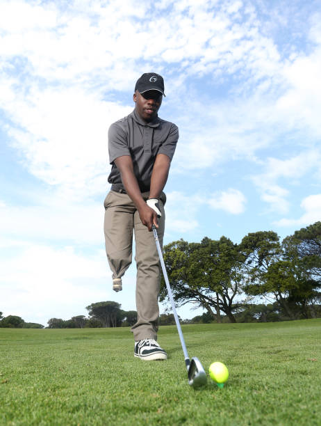 istock A young black man with only one leg playing golf 850846512