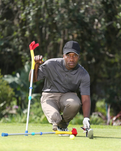 istock A young black man with only one leg playing golf 850847406