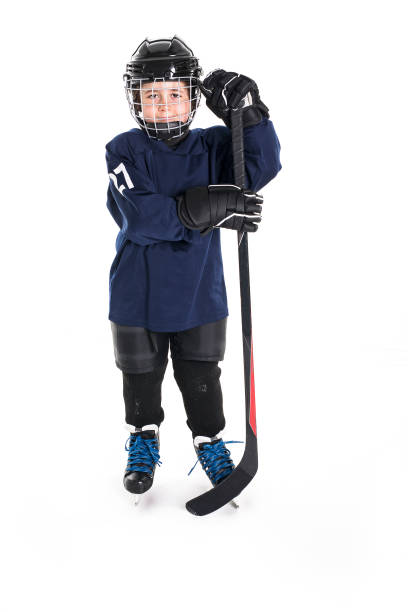 istock Young boy in ice hockey gear against white 850853486