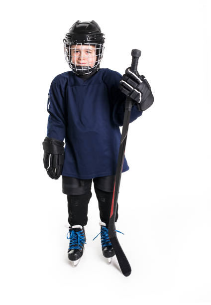 istock Young boy in ice hockey gear against white 850853654