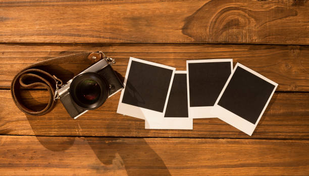 istock Instant photos on wooden floor 850854184