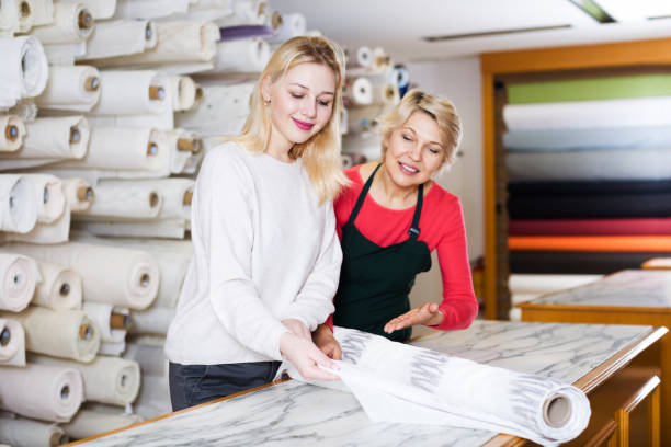 istock Woman seller displaying diverse fabrics 850854270