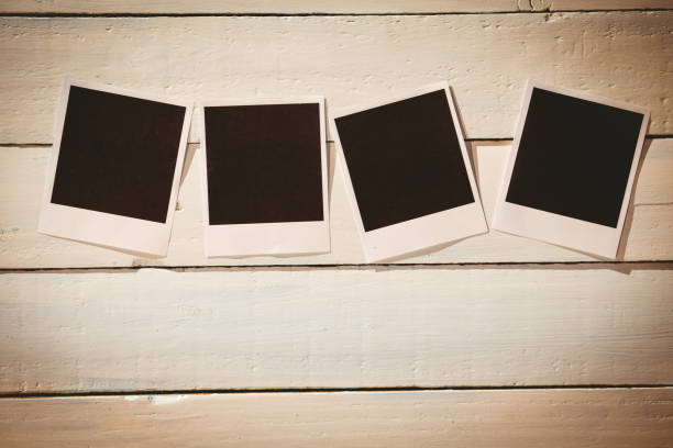istock Instant photos on wooden floor 850854748