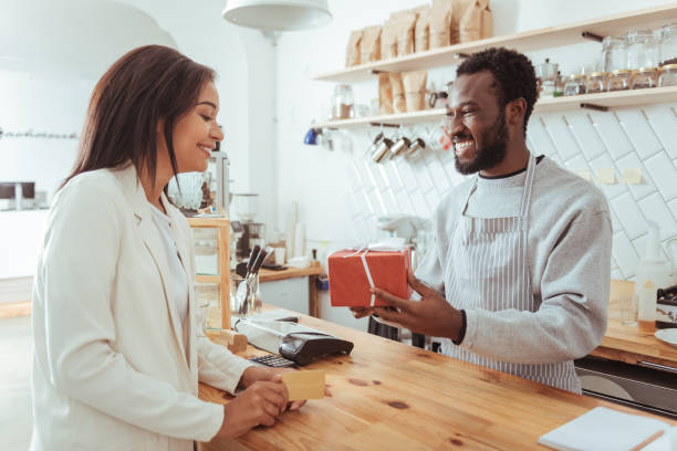 istock Smiling barista giving his customer a box with order 850858530
