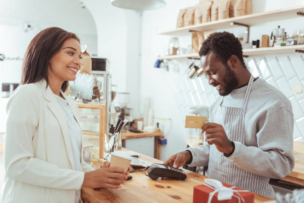 istock Smiling barista carrying out payment procedure 850858626