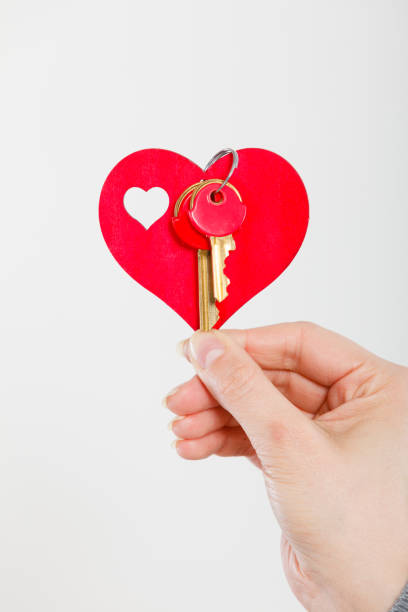 istock Female hand holds little heart with keys. 850864364