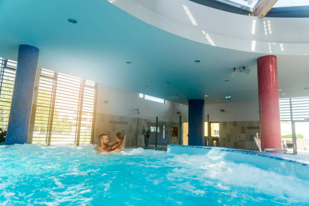 istock Romantic couple enjoying thermal bath spa and wellness center 850870026