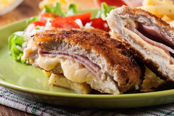 Cutlet Cordon Bleu with pork loin served with French fries and salad stock photo