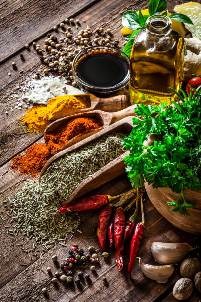 istock Spices and herbs on wooden kitchen table 850873160