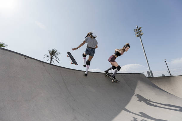 istock Two young women skateboarding in skatepark 850883624