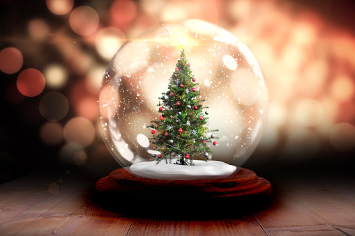Digitally generated Christmas tree in snow globe