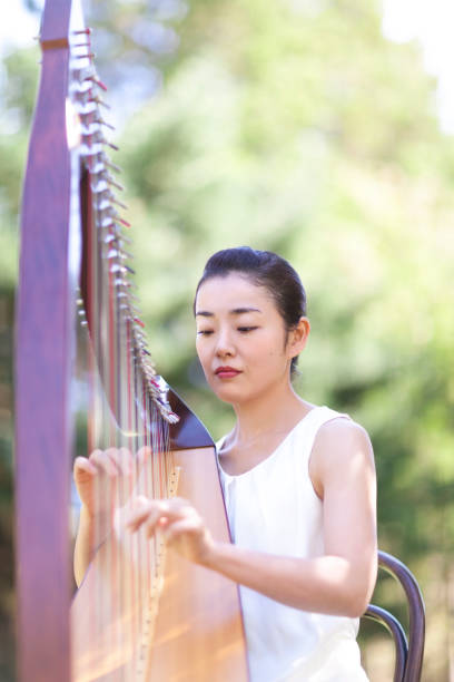 istock Woman Playing Harp Outdoors 850893574