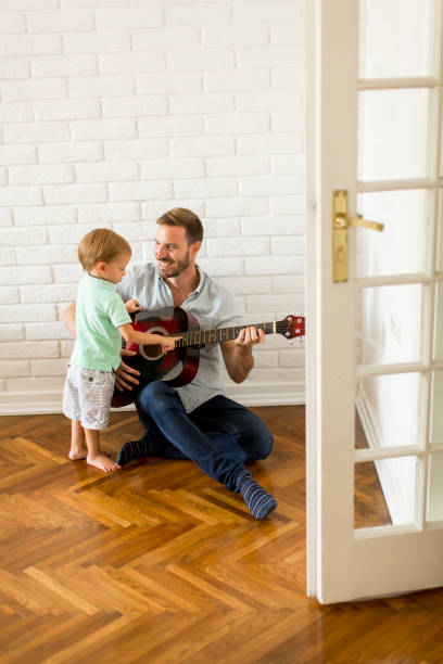 istock Father and little son with guitar 850894060