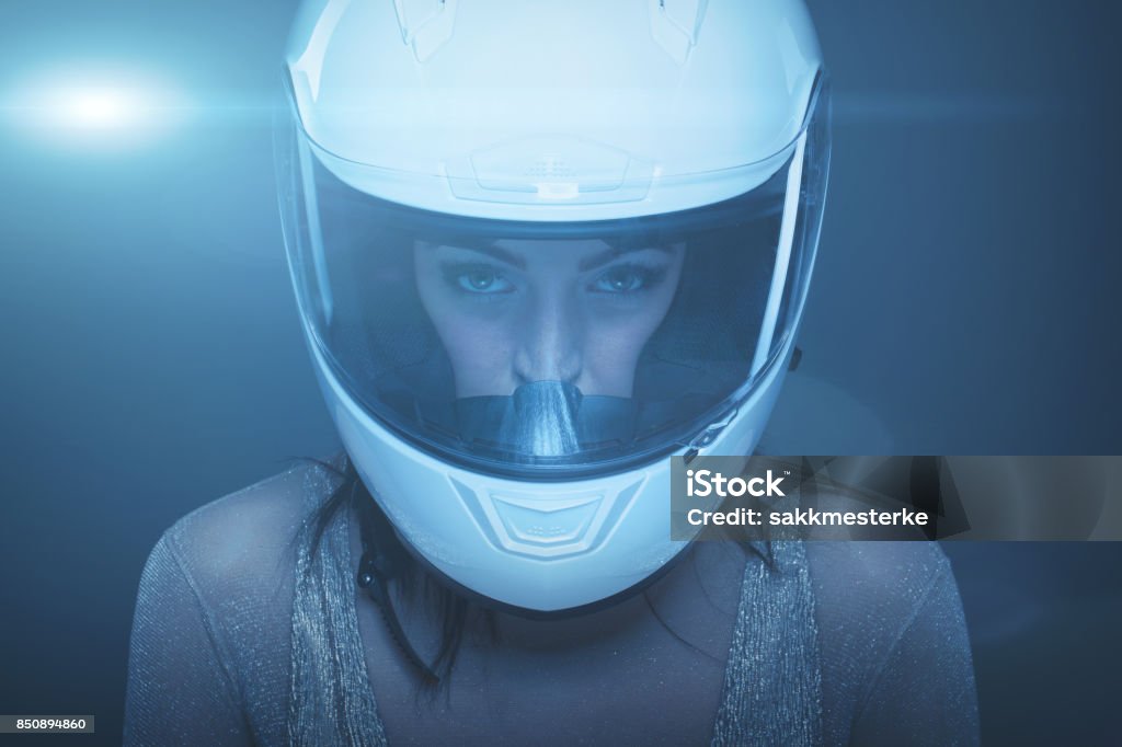Young fashionable woman in helmet portrait Young fashionable woman in helmet at night portrait, high extreme fashion One Woman Only Stock Photo