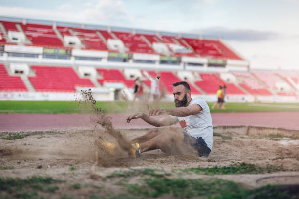 istock Athletic man landing in a sand 850895018