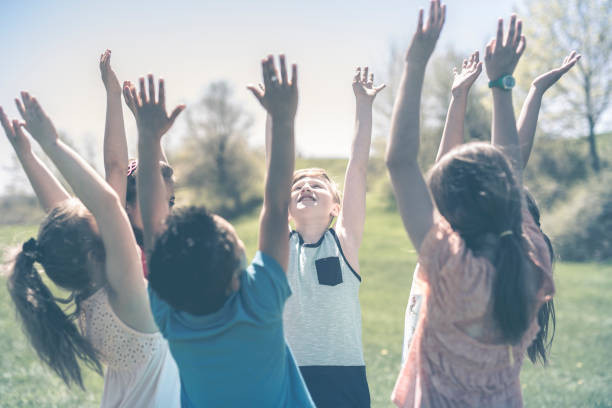 istock Group of child have fun on a field hand high 850905880
