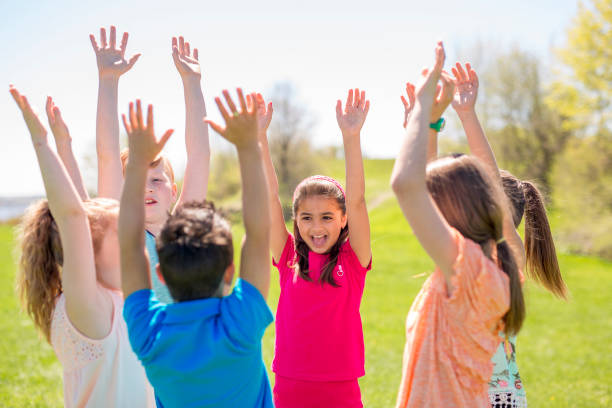 istock Group of child have fun on a field hand high 850906640