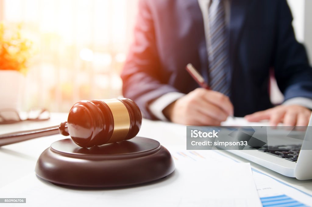 Wooden gavel on table. Attorney working in courtroom. Wooden gavel on table. Attorney working in courtroom. law attorney court judge justice gavel legal legislation concept Lawyer Stock Photo