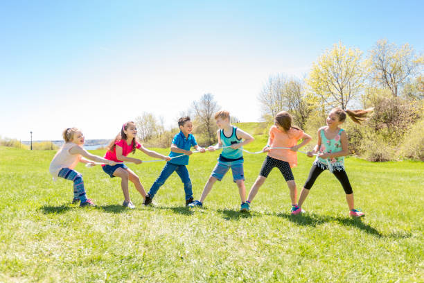 istock Group of child have fun on a field with rope 850910244