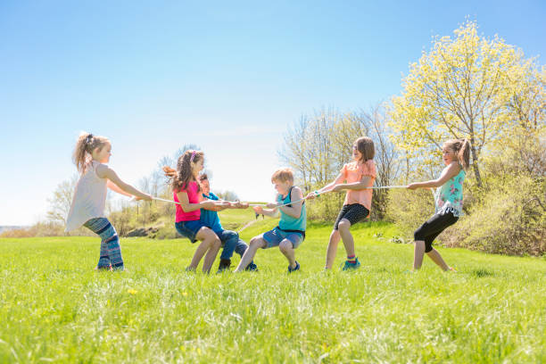 istock Group of child have fun on a field with rope 850911014