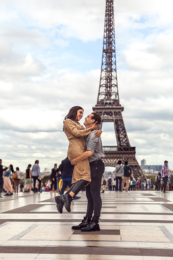 Lovely couple spending some days in vacation to Paris close to Tour Eiffel.