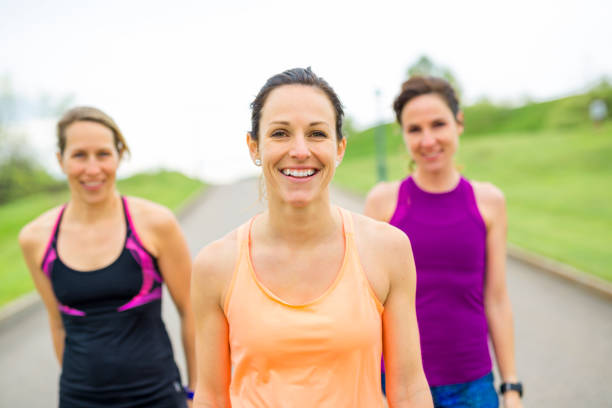 istock Three relaxed woman runners on a paved jogging daylight 850920744
