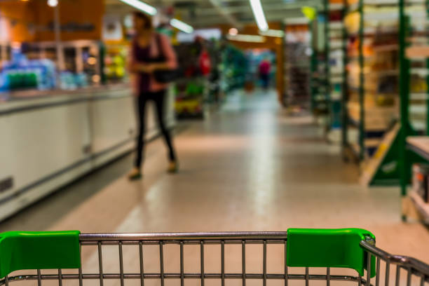 istock View from shopping trolley into abstract blurred supermarket aisle background 850925456