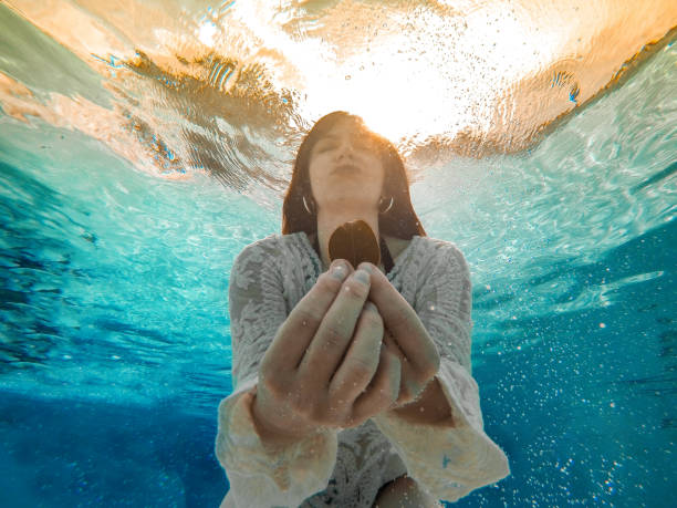istock Woman under water showing leaf 850925730