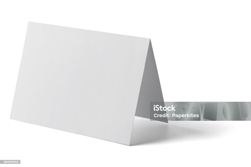 folded leaflet white blank paper template book close up of a  blank folded leaflet white paper on white background Blank Stock Photo