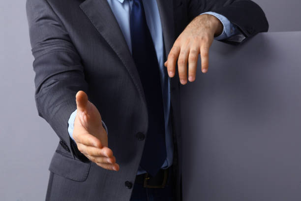 istock Man wearing a suit offering to shake hands 850930516