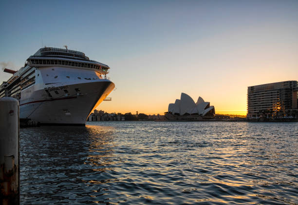 Sydney, Australia - November, 2019; Royal Carribean Cruise Liner, Radiance of the Seas docked at Circular Quay in Sydney. Sydney Opera House in background. This ship boasts floor to ceiling windows and an outdoor cinema playing first run movies.