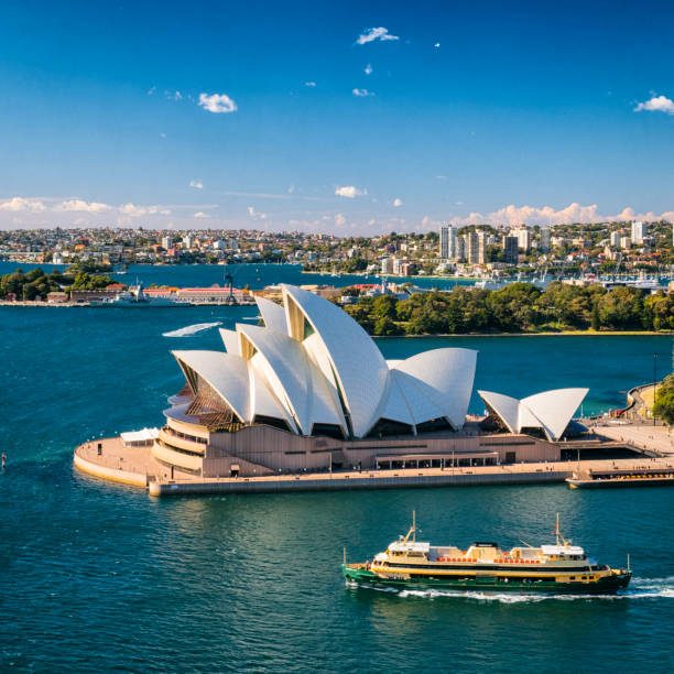Sydney, Australia - August 7, 2017: Boats and ferries ply the waters of Circular Quay in Sydney, Australia. The iconic form of the Sydney Opera House and the Royal Botanic Gardens beyond complete the scene.