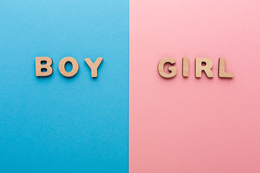 Words Boy and Girl on bright backgrounds. Unknown baby gender, uncertainty and doubt concept