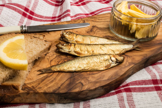 istock golden brown smoked sprats on wooden board 850937932