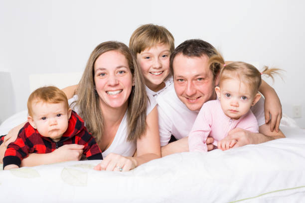 istock five member Young Family Having Fun In Bed 850940540