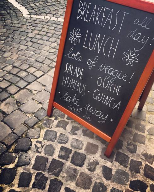 Sidewalk cafe blackboard with menu displayed outside on Bruges street, Belgium.